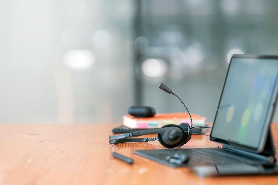 Headset, Hotline Support Concept in Office. VOIP Headset on Desk