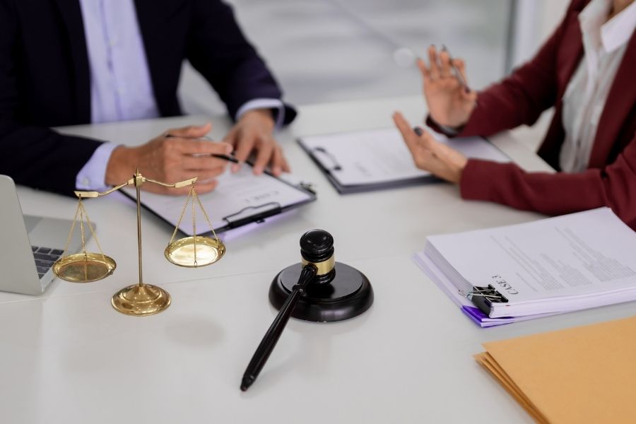 Legal professionals discuss contract terms office meeting lawyer